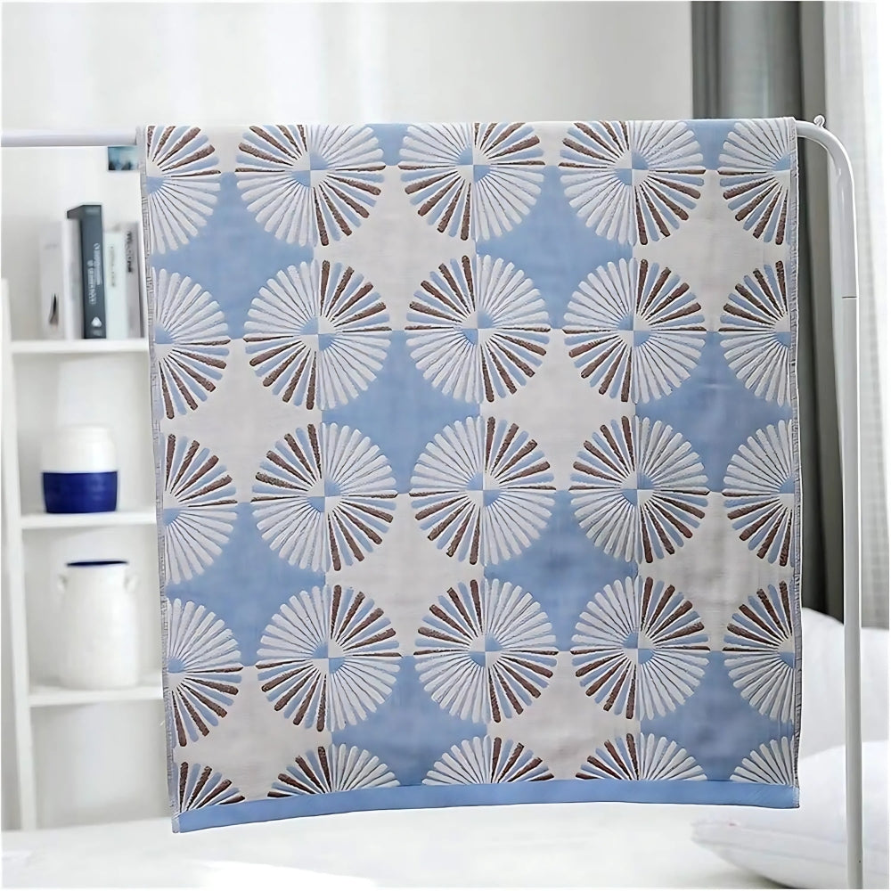 Blue and white Dahlia Blossom cotton bath towel with a repeating floral pattern.