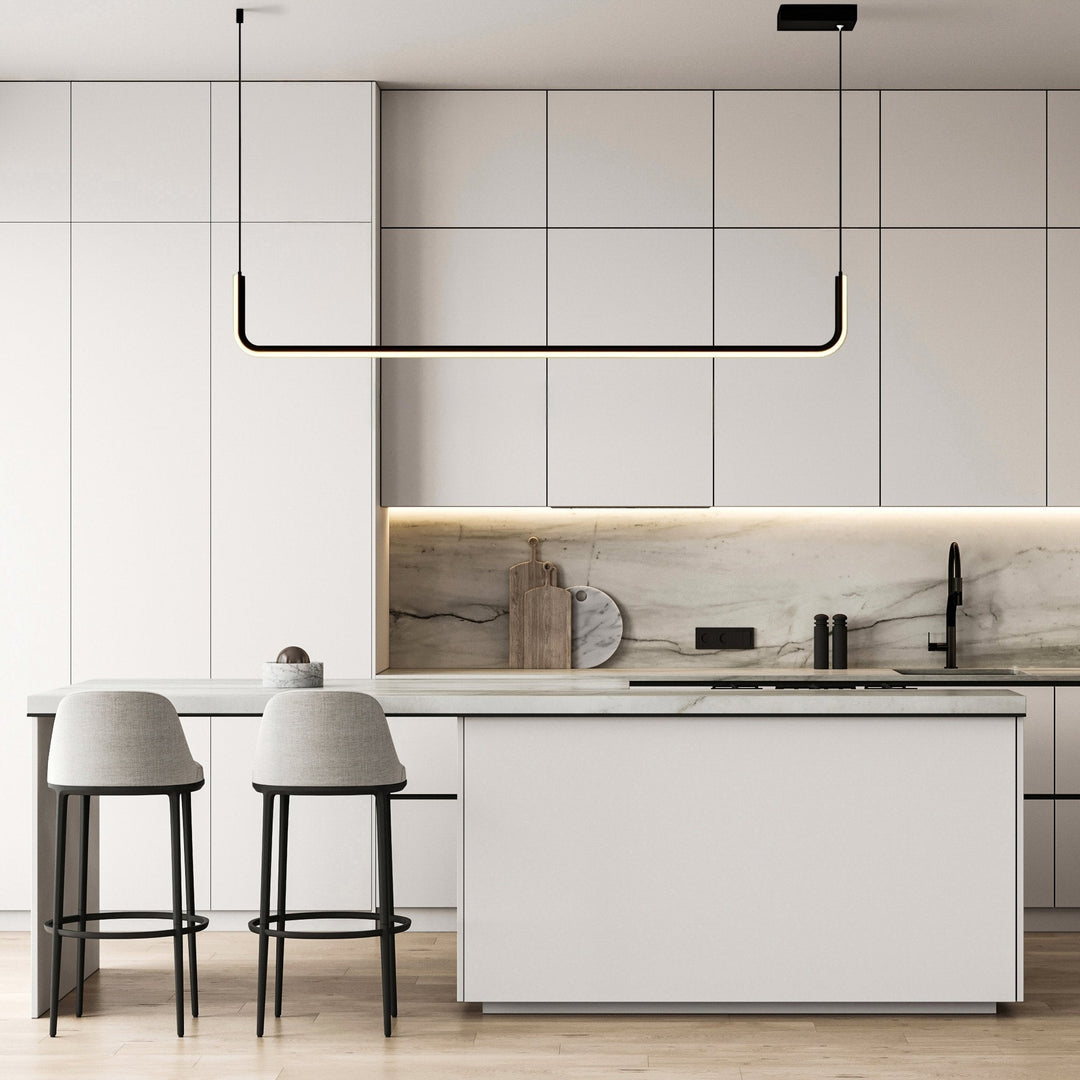 Modern adjustable pendant light with a black frame and integrated LED, suspended over a kitchen island.