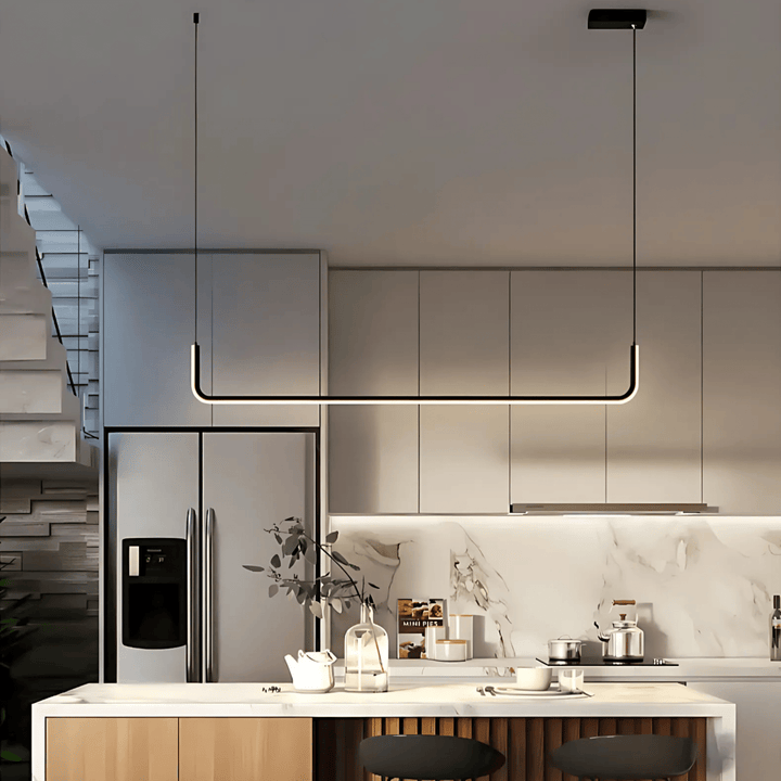 Modern adjustable pendant light with a black metal frame and integrated LED, hanging over a kitchen island.
