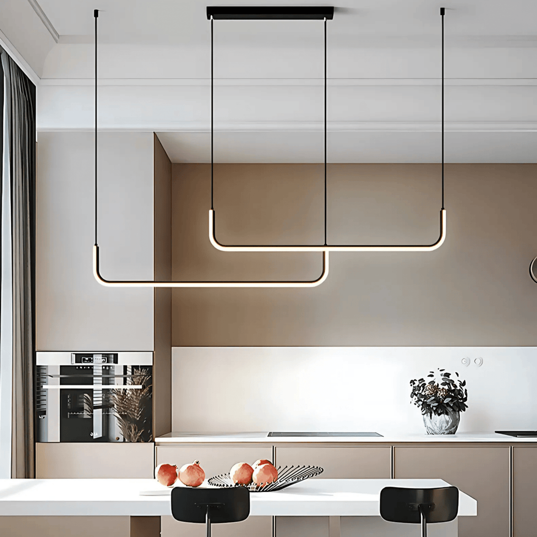 Two modern black adjustable pendant lights with U-shaped LED bars hang over a kitchen island.