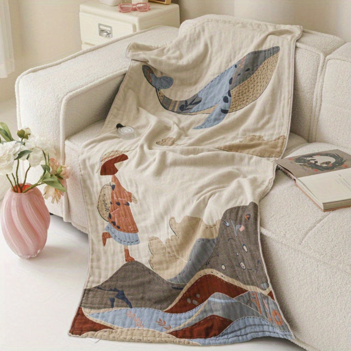 Cotton towel blanket with a whale and a child walking on mountains design.