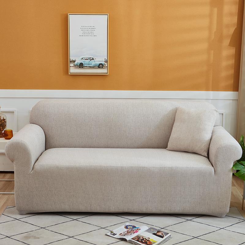 Egg shell colored couch cover with a cross pattern, featuring a pillow on the right side.