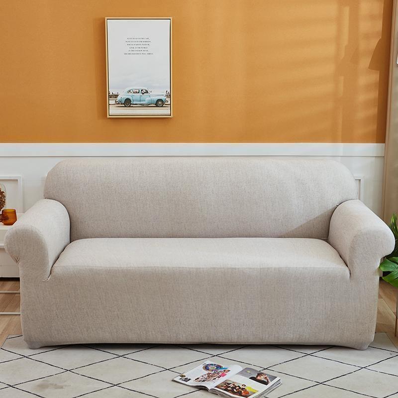 Egg shell colored couch cover with a cross pattern on a sofa.