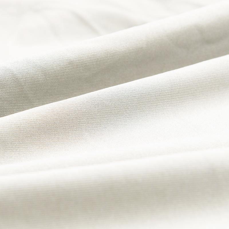 Close-up of alabaster white couch cover fabric with a textured weave.