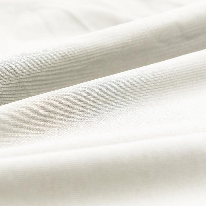 Close-up of alabaster white couch cover fabric with a textured weave.