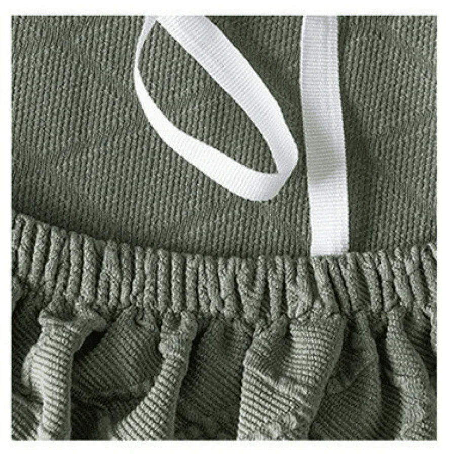 Close-up of a pale green wide jacquard couch cover with a white drawstring.
