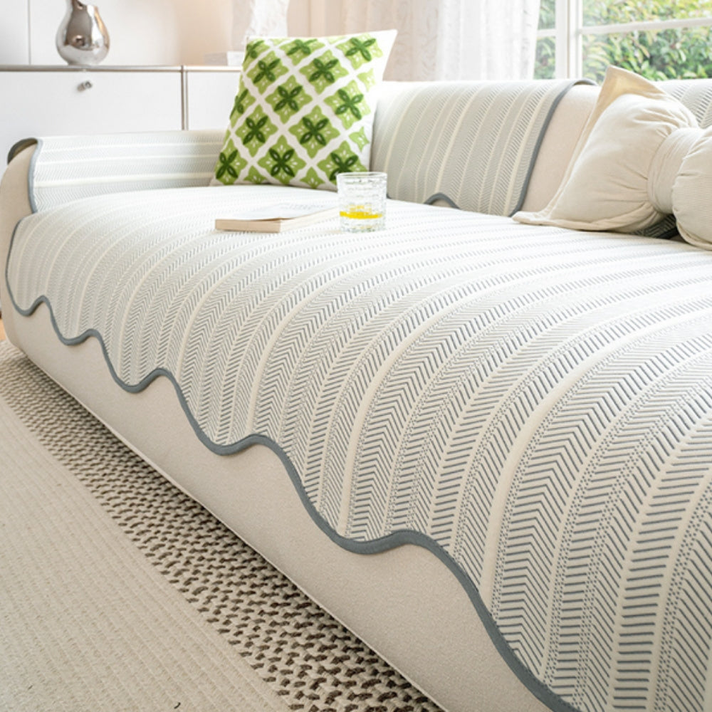 Herringbone sofa cover with a scalloped edge, featuring a blue and white chevron pattern.