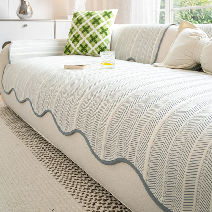 Herringbone sofa cover with a scalloped edge, featuring a blue and white chevron pattern.