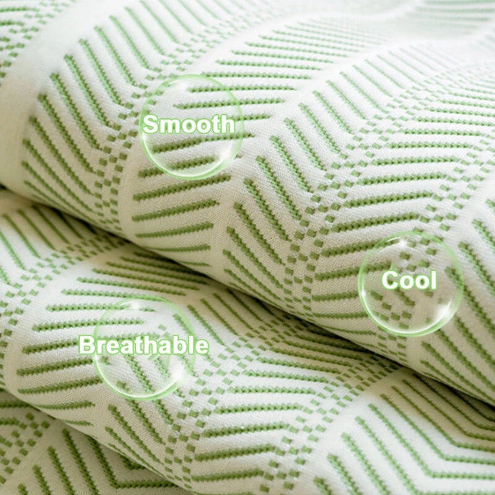 Close-up of a white and green herringbone sofa cover, highlighting its smooth, cool, and breathable texture.