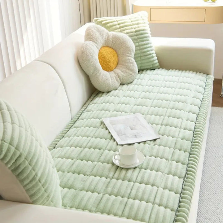 Plush microfiber sofa cover in light green with hand-pleated texture, featuring decorative pillows.