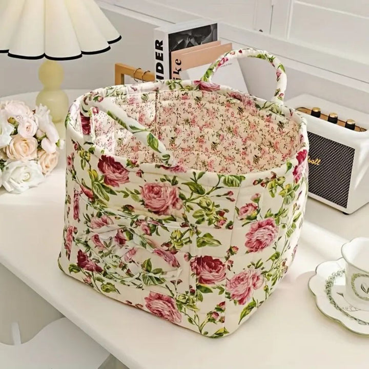 Floral canvas storage basket with handles, lined with a smaller floral pattern.