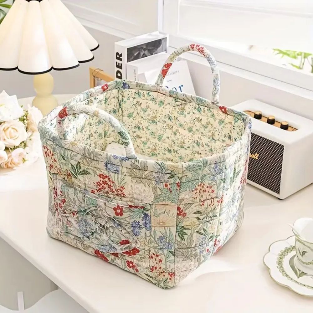 Floral canvas storage basket with handles, featuring a floral pattern on the exterior and interior.