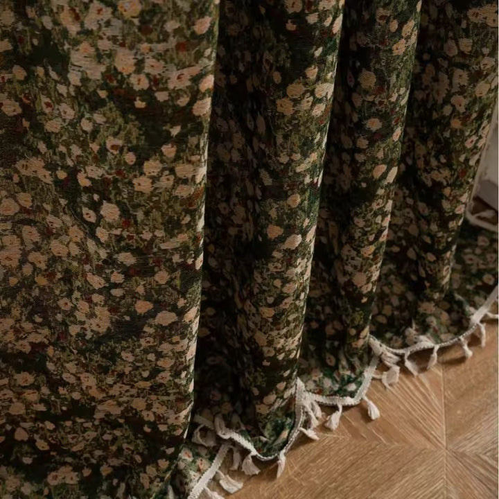 Green floral tapestry curtain with white fringe trim.