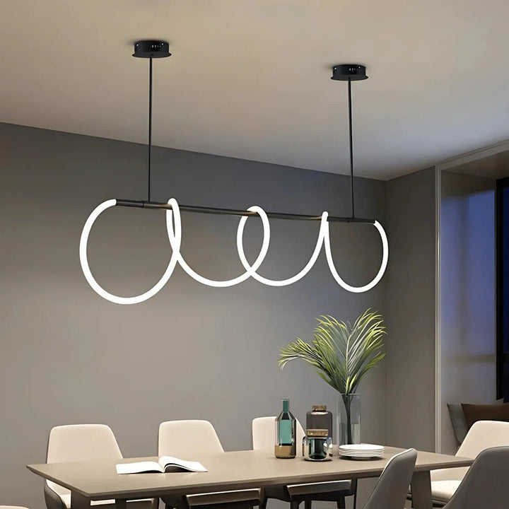 Black chandelier with a wavy silicone LED rope design hanging over a dining table.