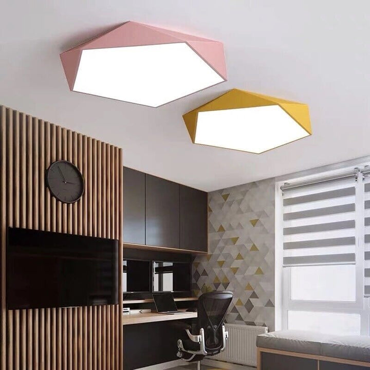 Pink and yellow geometric flush mount ceiling lights in a modern room.