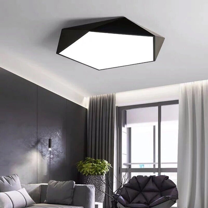 Modern geometric flush mount ceiling light with a black frame and white interior.
