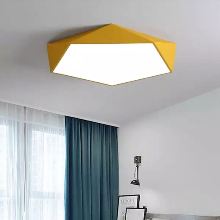 Yellow geometric flush mount ceiling light with a white diffuser.