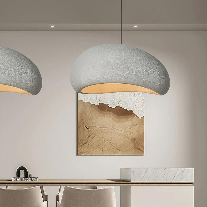 Wabi-Sabi pendant light in rustic grey, hanging over a dining table.