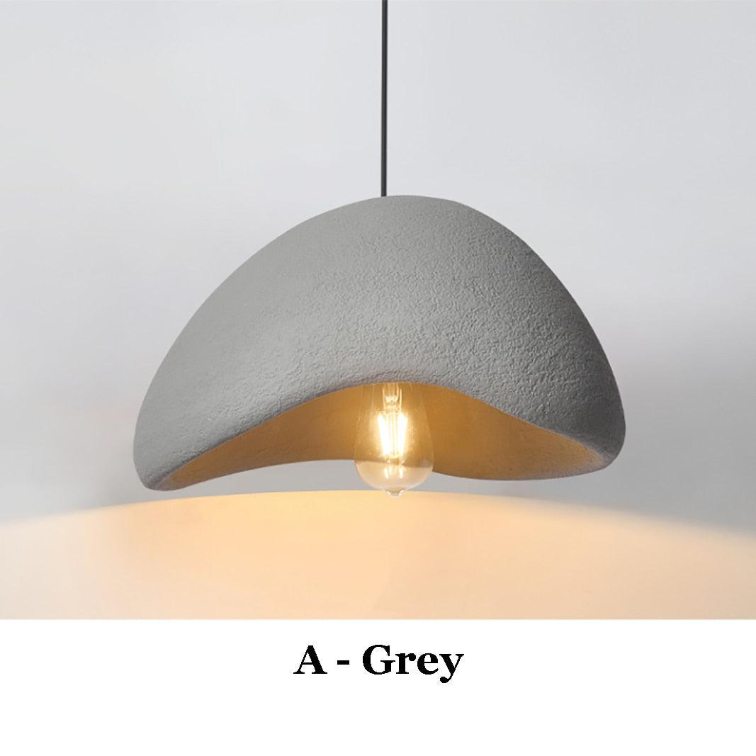 Grey Wabi-Sabi pendant light with a textured finish and exposed bulb.
