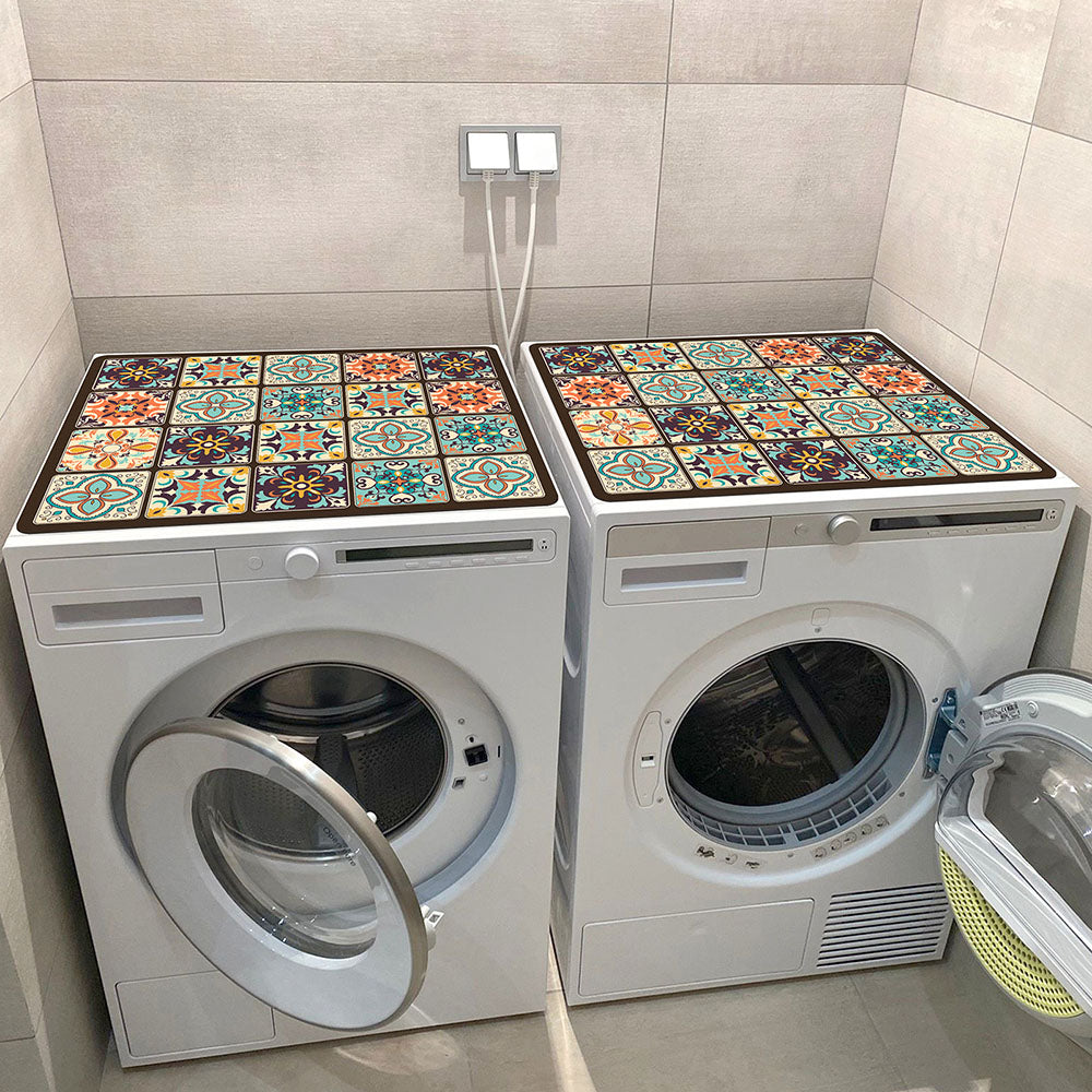 Two white washing machines topped with decorative microfiber mats featuring a colorful mosaic tile pattern.