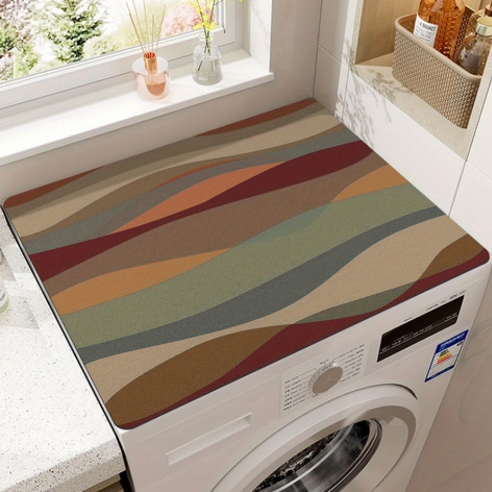 Microfiber appliance mat with a wavy abstract pattern in earth tones on a washing machine.