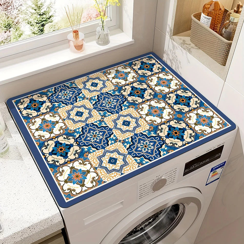 Microfiber appliance mat with a blue and gold geometric tile pattern on a washing machine.