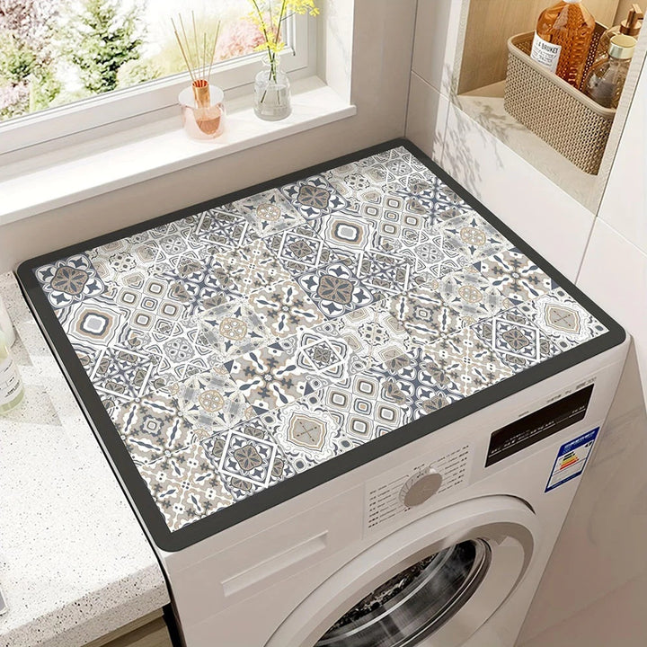 Microfiber appliance mat with a geometric tile pattern on top of a white washing machine.
