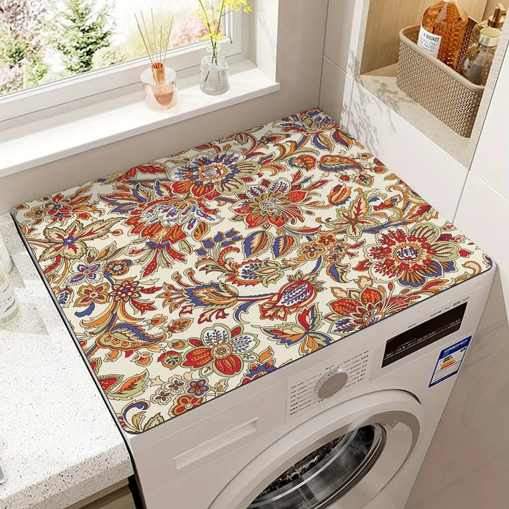 Microfiber appliance mat with a colorful floral pattern placed on top of a white washing machine.