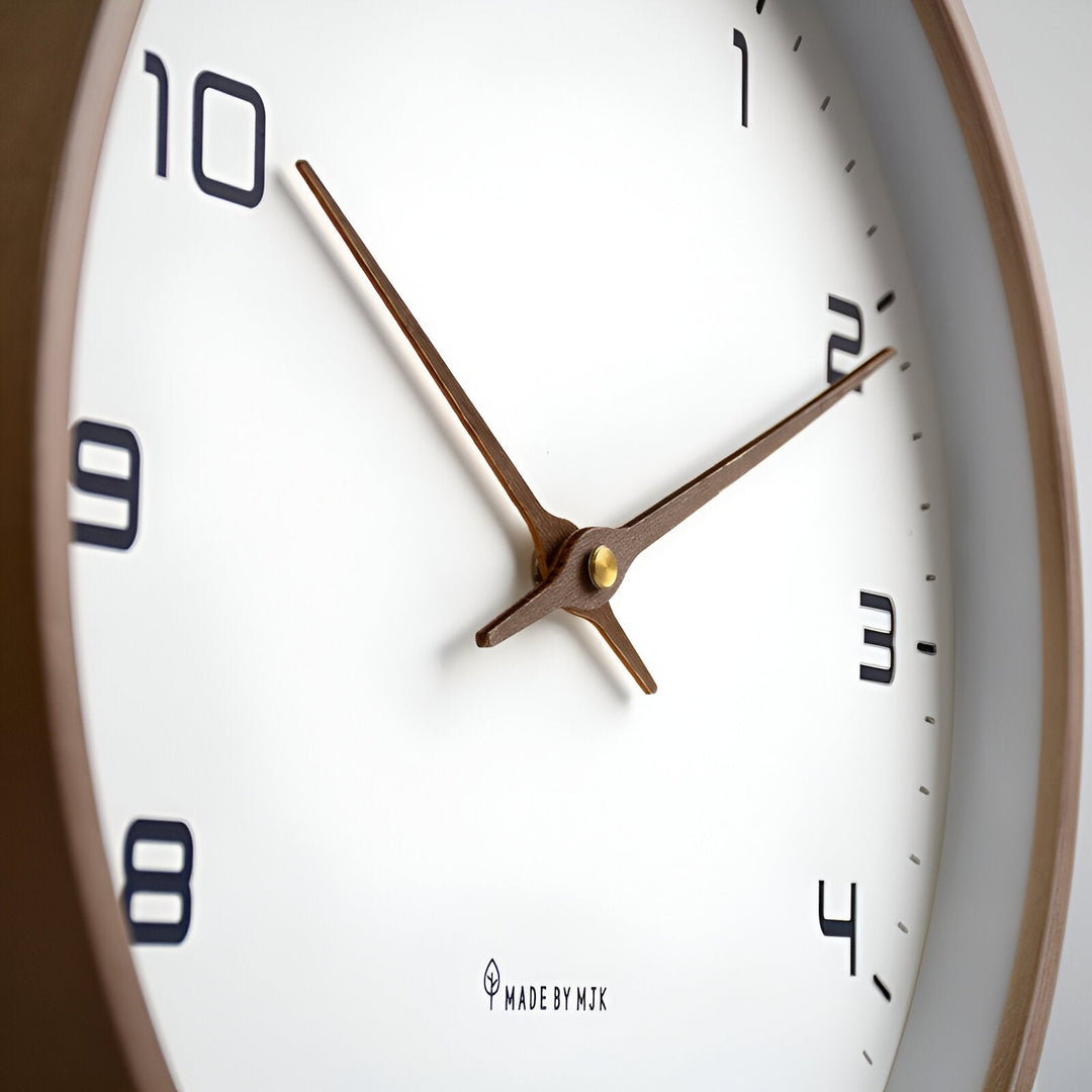 Close-up of a Nordic Wood Wall Clock with a white face, black numbers, and wooden hands pointing to 10 and 2.