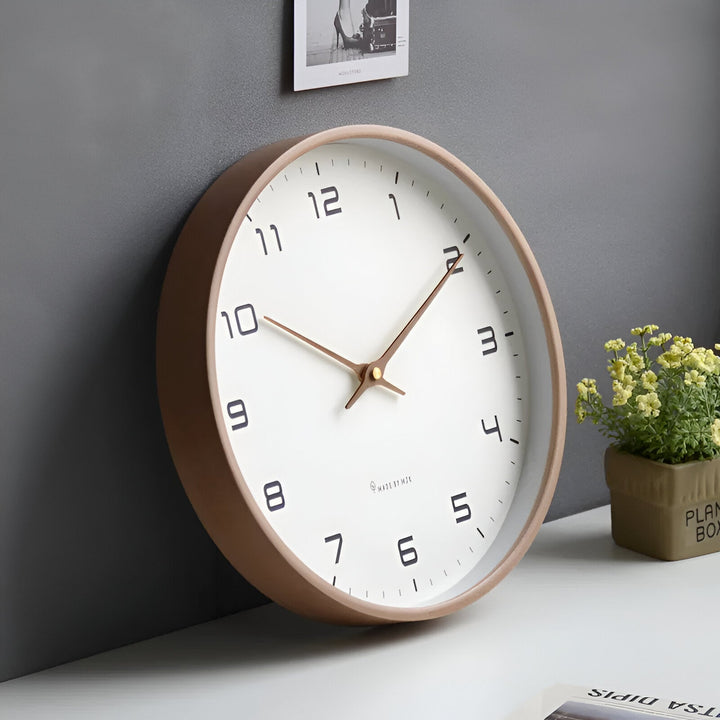 Nordic Wood Wall Clock with a white face, black numbers, and a light wood frame.