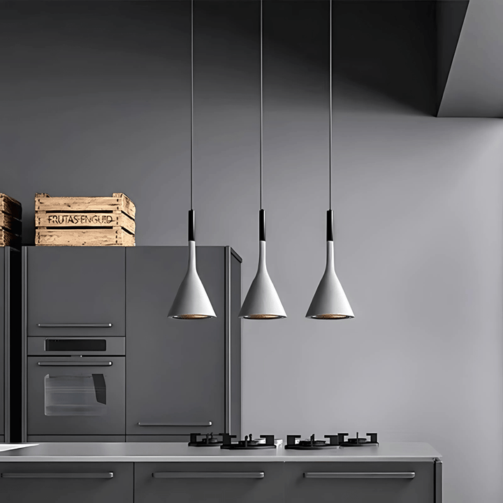 Three white cone pendant lights hanging over a modern kitchen counter.