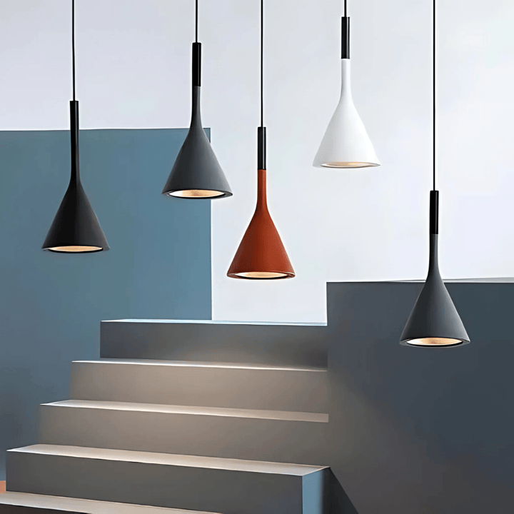 Five cone-shaped pendant lights in black, gray, rust, and white hanging above a staircase.