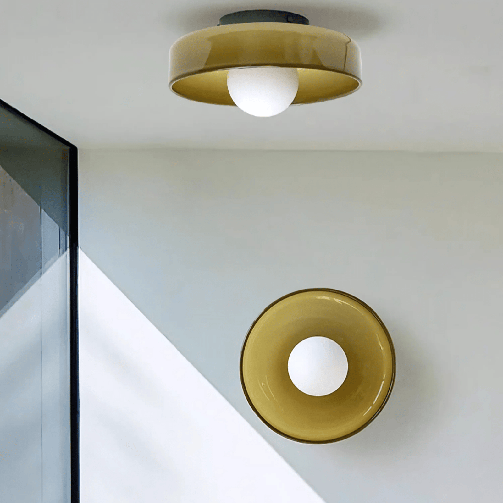 Flush mount ceiling light with a golden shade and a white globe bulb.