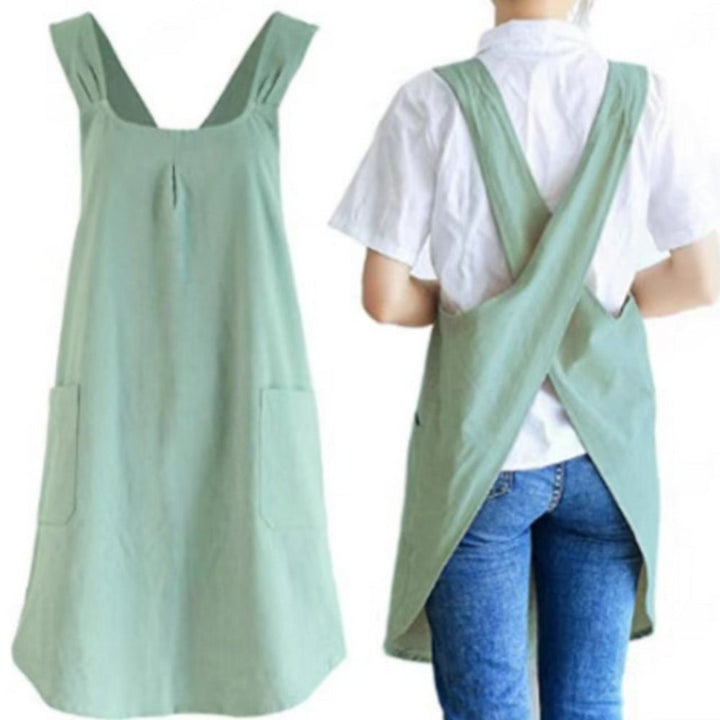 Light green Korean cross-back apron dress with wide straps and two front pockets.
