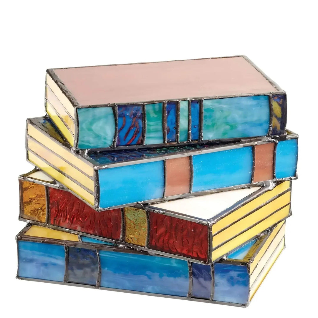 Stack of four stained glass boxes designed to look like books, with colorful panels and leaded seams.