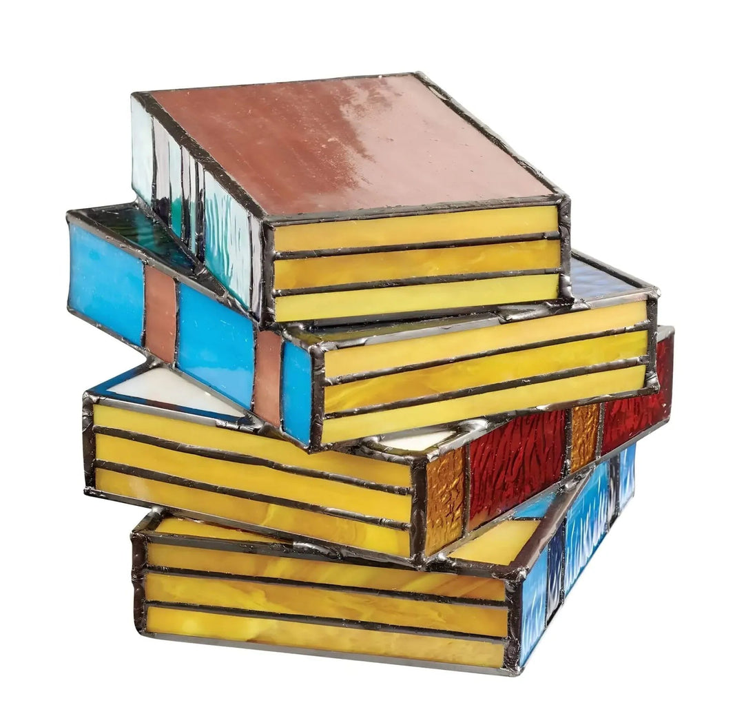 Stack of stained glass books lamp with yellow, blue, red, and brown panels.