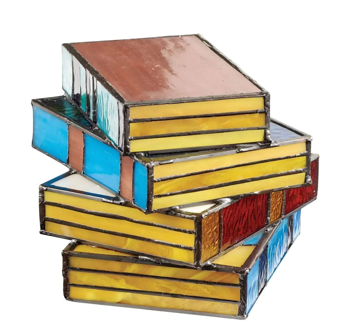 Stack of stained glass books lamp with yellow, blue, red, and brown panels.