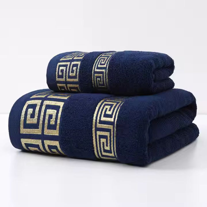 Navy blue cotton towel set with gold Greek key pattern.