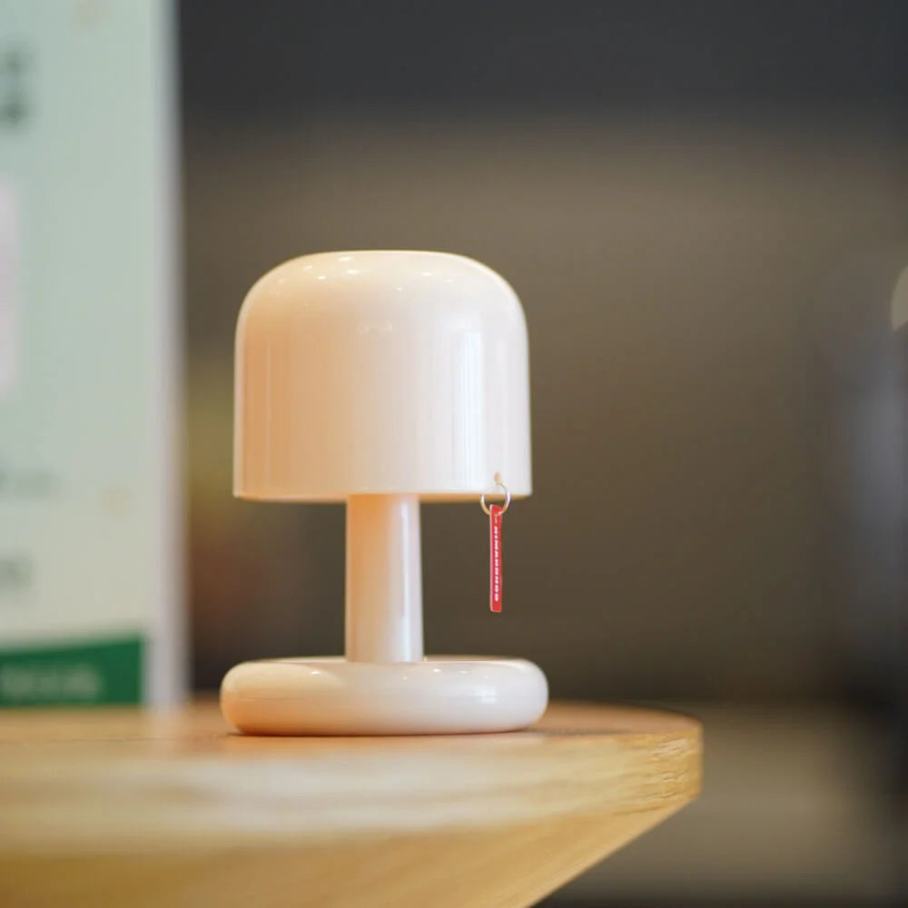 White USB rechargeable table lamp with a red tag hanging from the shade.