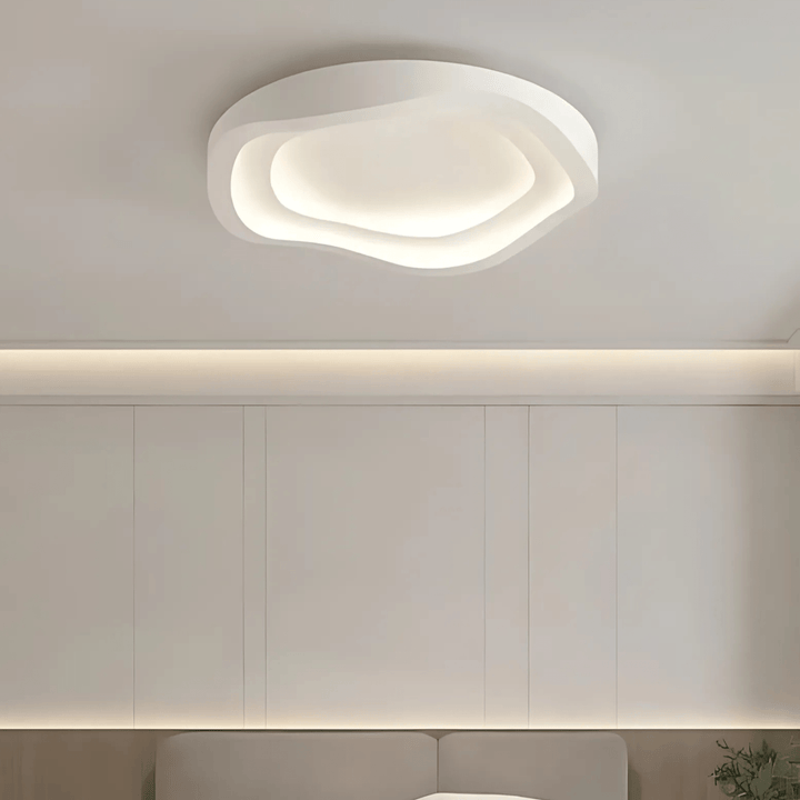 Contemporary metal flush mount ceiling light with an organic, layered design and integrated LED.