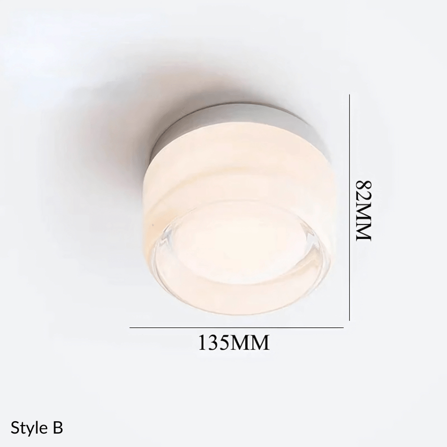 Style B metal and glass wall sconce, 135mm wide and 82mm high.