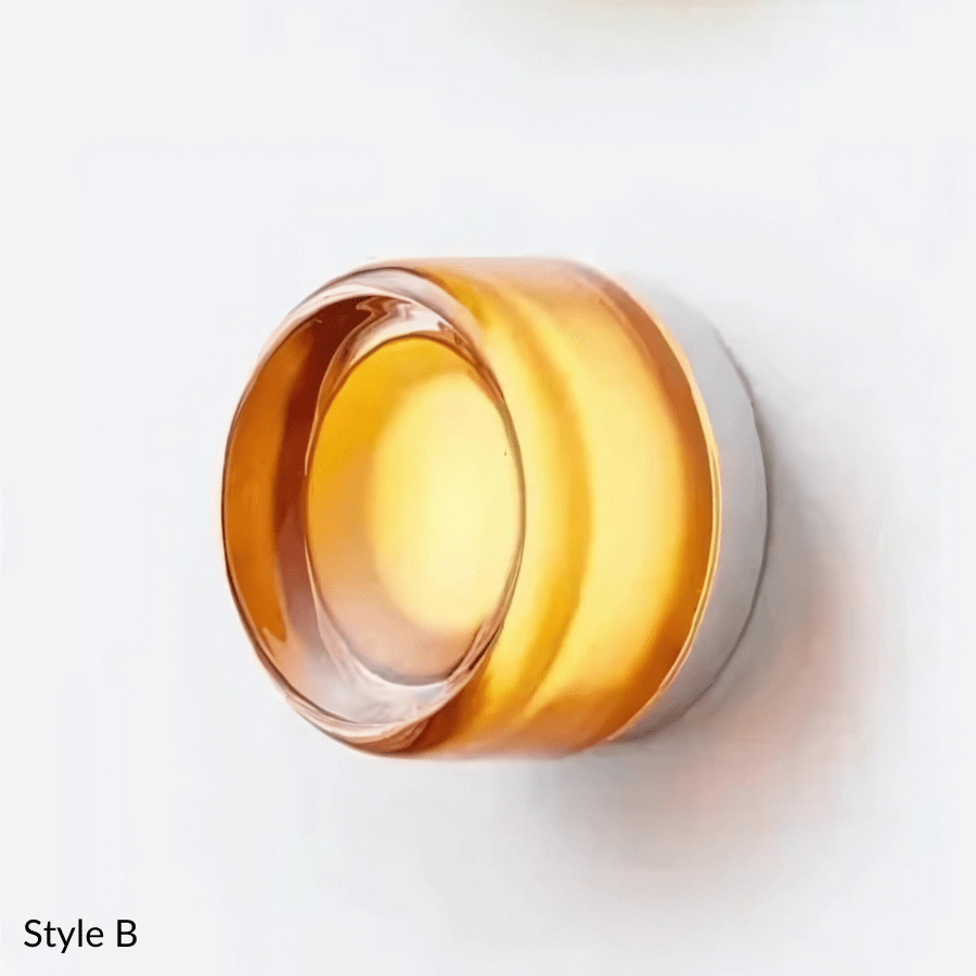 Style B wall sconce with a round, amber glass shade and a silver metal base.