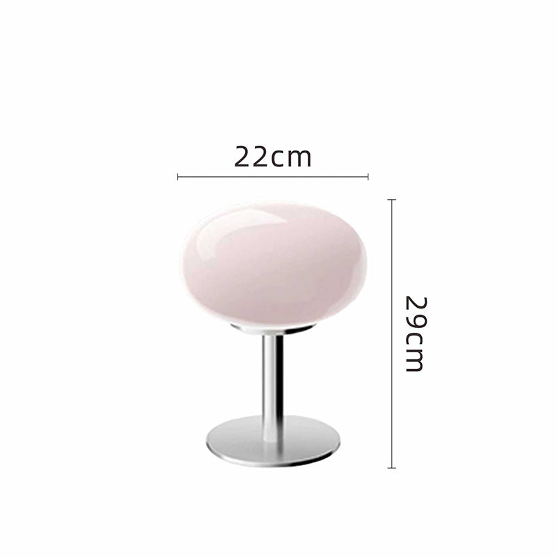 Pink glass table lamp with a chrome base, 22cm wide and 29cm tall.