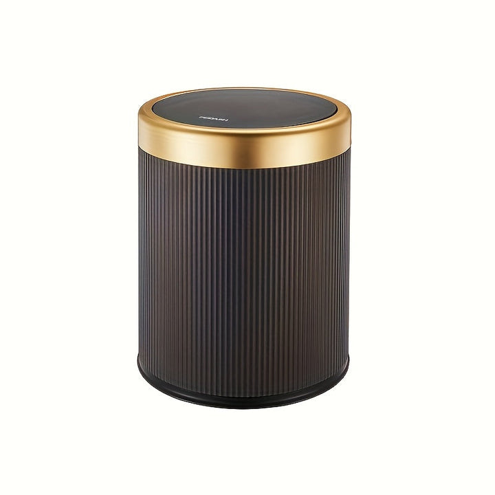 Dark ribbed cylindrical trash can with a gold rim and black press-top lid.
