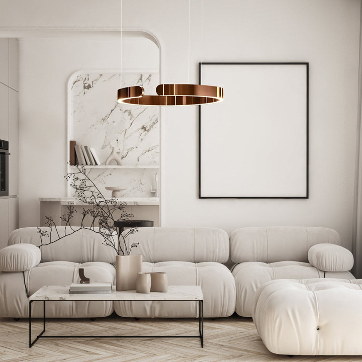 Modern copper metal pendant light with a circular design, suspended over a living room coffee table.
