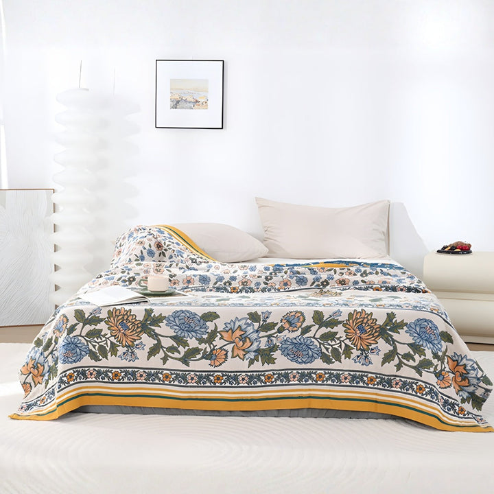 Meadow Bliss Boho Floral Blanket with blue and orange flowers on a cream background.