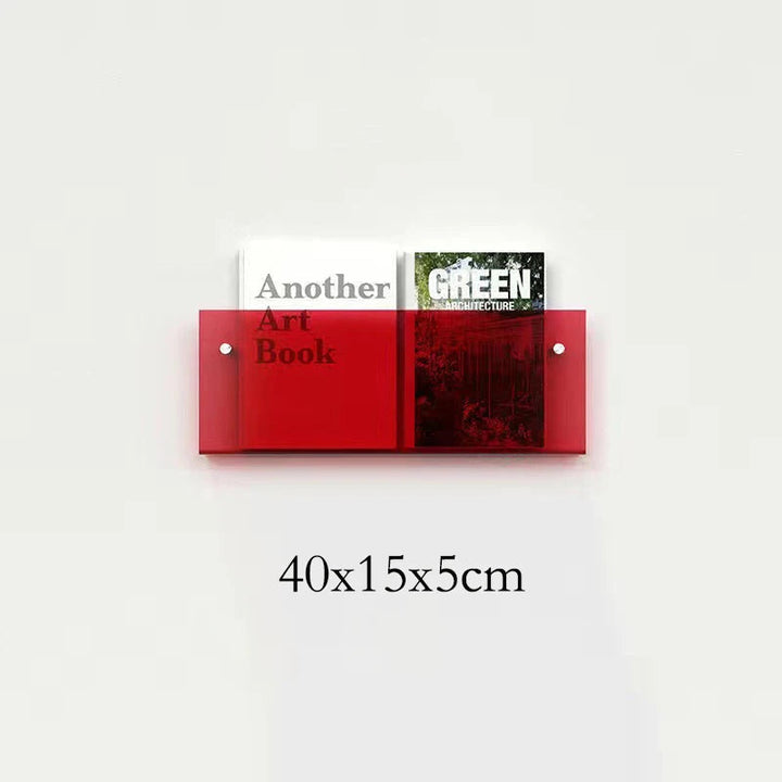 Red acrylic floating shelf holding two books, one titled &