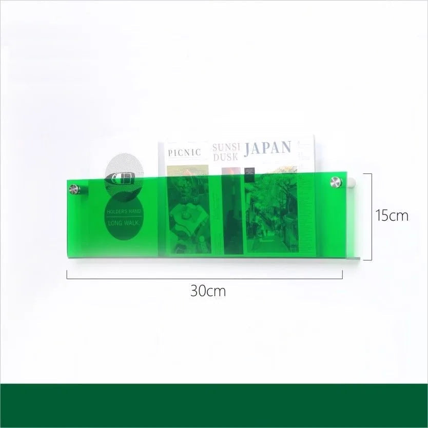 Green acrylic floating shelf, 30cm wide and 15cm high, holding magazines.