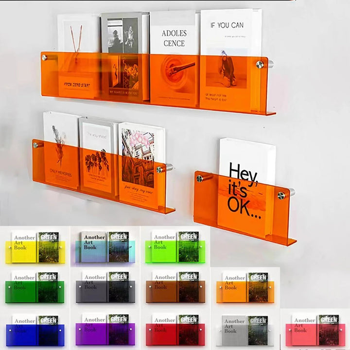 Orange acrylic floating shelves displaying books and art on a white wall, with smaller colored shelves below.