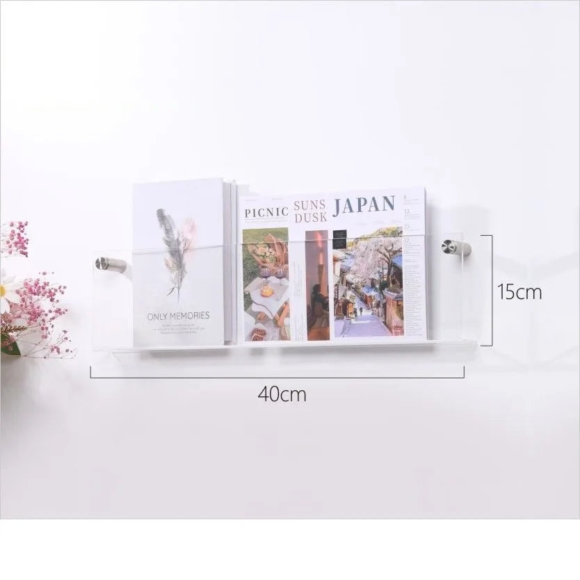 A 40cm x 15cm clear acrylic floating shelf displaying two magazines and a booklet.